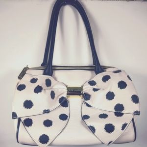 Betsey Johnson hand bag with a black and white polka dot bow.